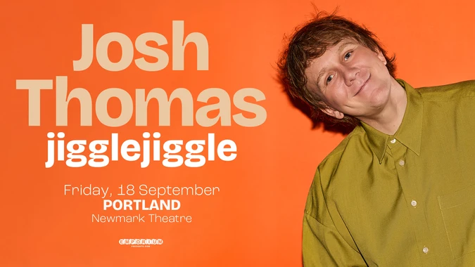 Photo of Josh Thomas, wearing a green button-up shirt, with text: Josh Thomas jiggle jiggle, on an orange background
