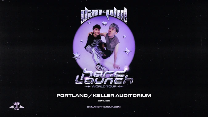 Promotional image for "Dan and Phil Hard Launch World Tour" featuring Dan and Phil in futuristic attire, set against a purple background with stars. Date: 09.17.26, Portland/Keller Auditorium.