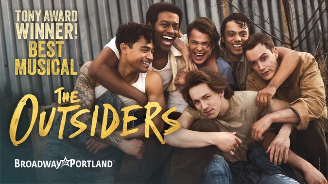 Broadway in Portland promotional image for Tony Award-winning musical The Outsiders, showing six young men huddled together, smiling; bold yellow title text.